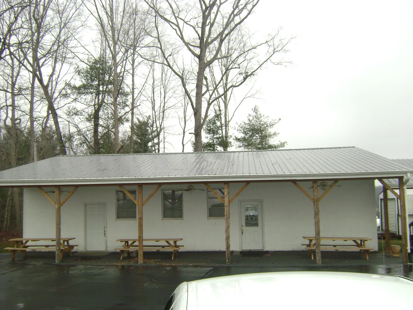 Gray metal roof over a block building with a timber post porch in Grantsville
